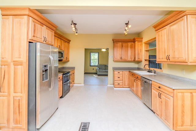kitchen with light brown cabinets, sink, appliances with stainless steel finishes, and track lighting