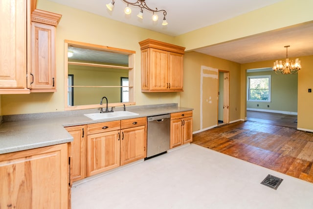 kitchen featuring sink, stainless steel dishwasher, light hardwood / wood-style flooring, light brown cabinetry, and a notable chandelier