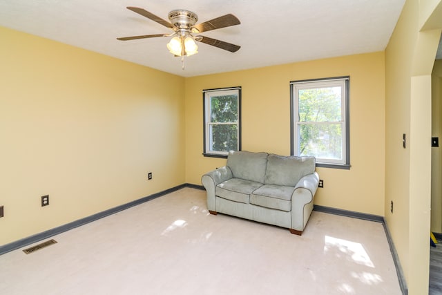 living room with ceiling fan and light colored carpet