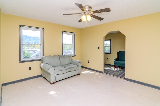 unfurnished living room with carpet floors and ceiling fan