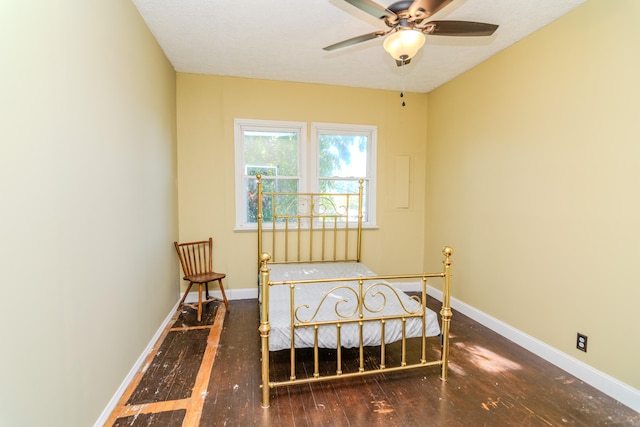 bedroom featuring dark hardwood / wood-style floors and a textured ceiling