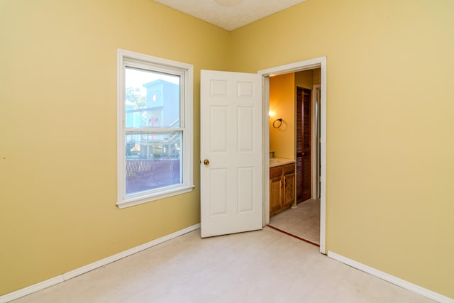 carpeted spare room with a textured ceiling