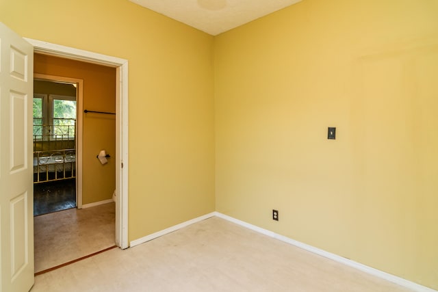 carpeted spare room with a textured ceiling
