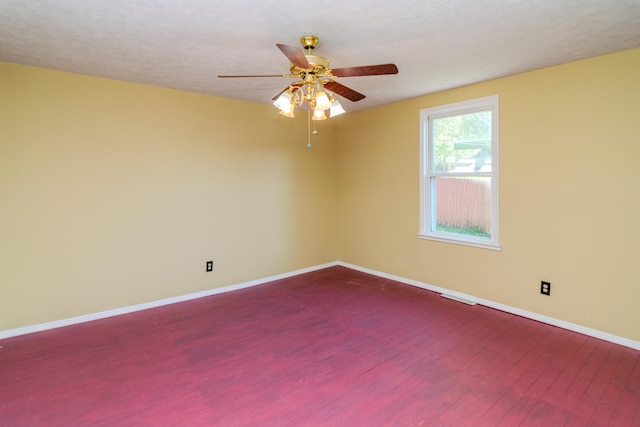 spare room featuring wood-type flooring, a textured ceiling, and ceiling fan