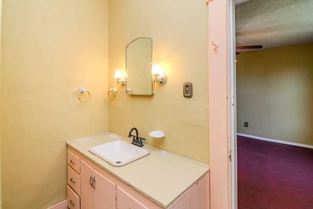 bathroom featuring vanity, wood-type flooring, and a textured ceiling