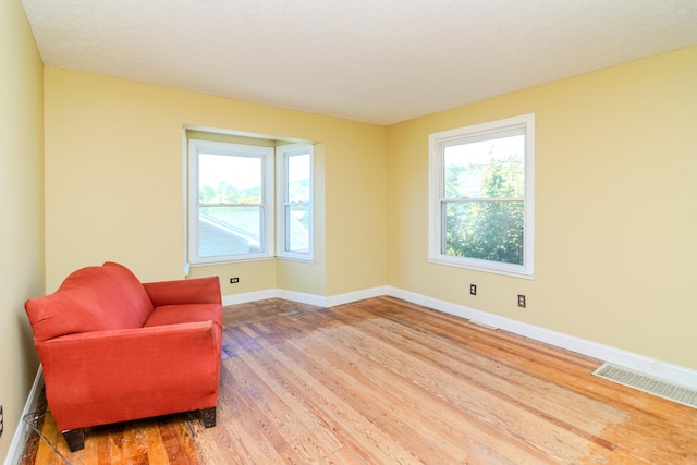 sitting room featuring hardwood / wood-style flooring and a textured ceiling