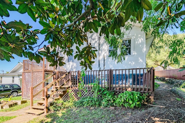 view of property exterior featuring a wooden deck