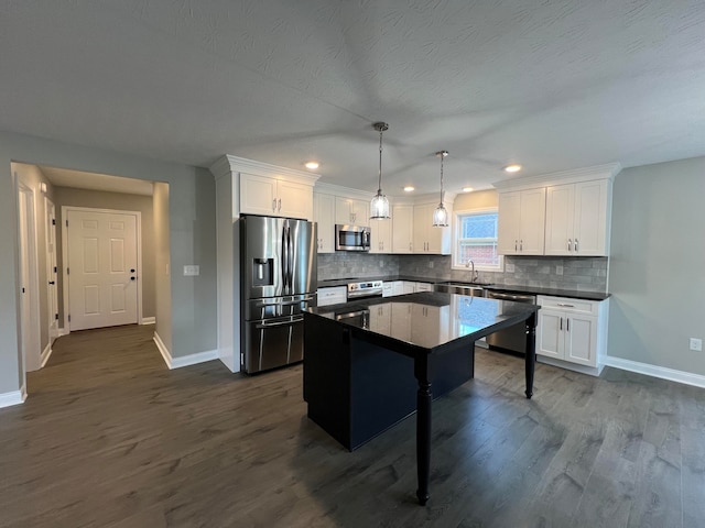 kitchen featuring dark hardwood / wood-style floors, a center island, a breakfast bar, and appliances with stainless steel finishes