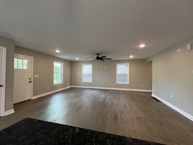 interior space featuring ceiling fan, dark hardwood / wood-style flooring, and a textured ceiling