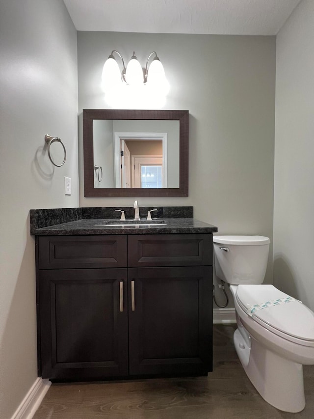 bathroom featuring hardwood / wood-style floors, vanity, and toilet