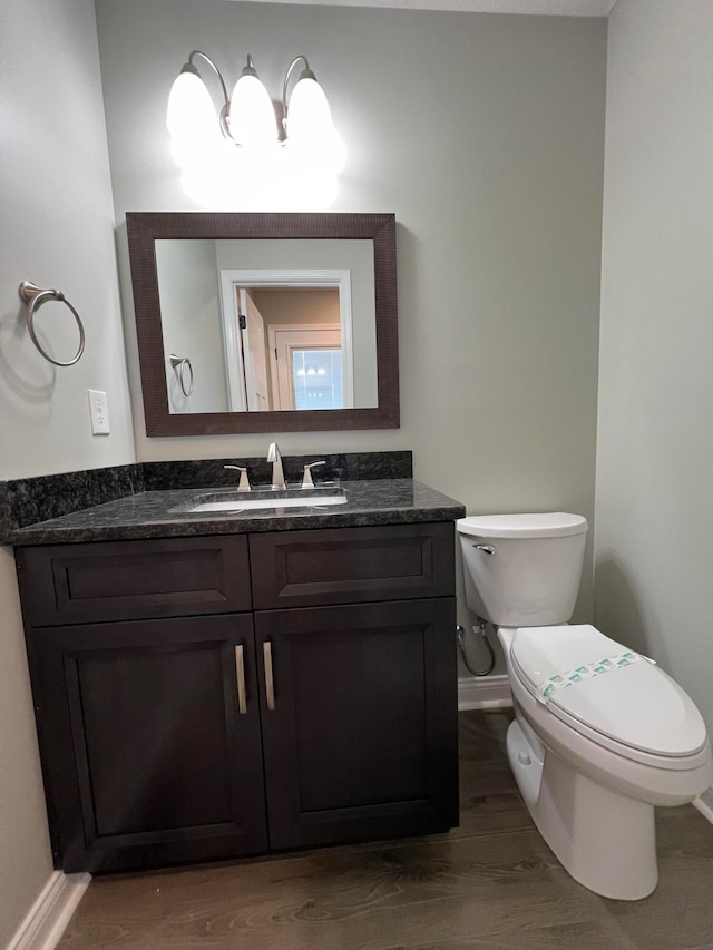 bathroom featuring hardwood / wood-style floors, vanity, and toilet