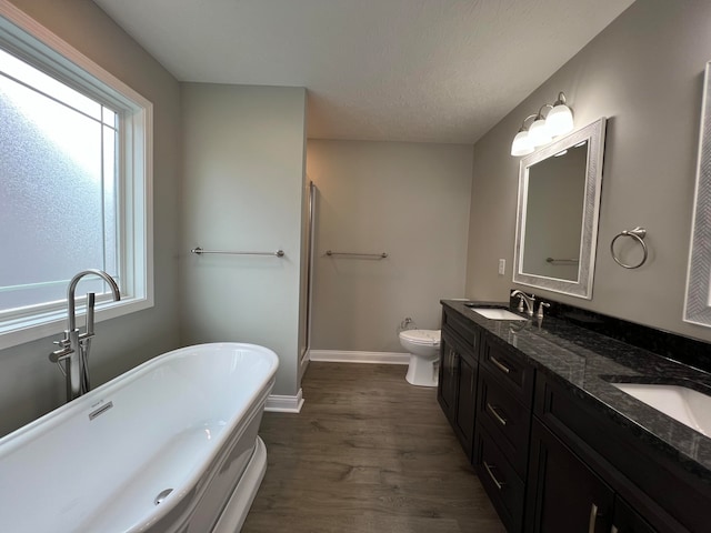 full bathroom featuring plenty of natural light, vanity, hardwood / wood-style floors, and toilet