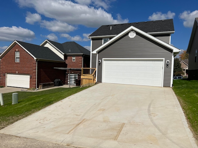 view of front of home with a front yard and a garage