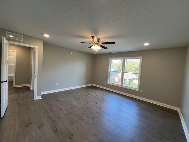 spare room featuring a textured ceiling, dark hardwood / wood-style flooring, and ceiling fan