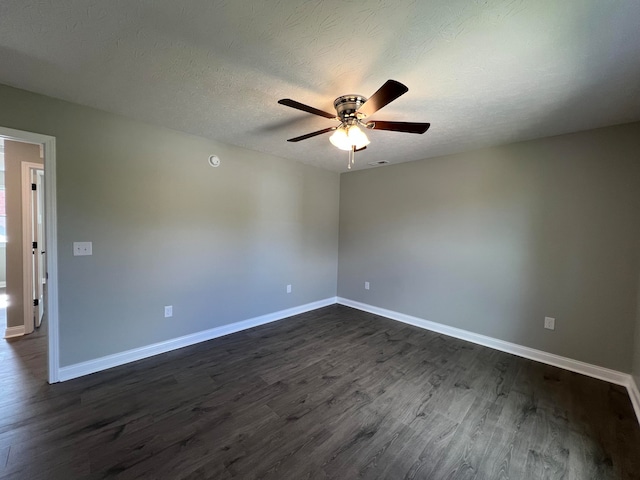 empty room with dark hardwood / wood-style floors, ceiling fan, and a textured ceiling