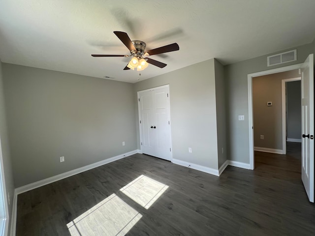 unfurnished bedroom with dark hardwood / wood-style floors and ceiling fan