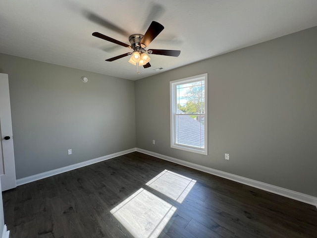 empty room featuring dark hardwood / wood-style floors and ceiling fan