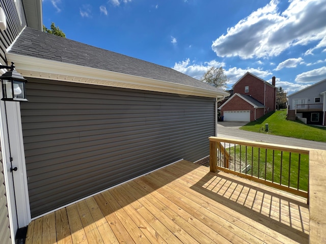 wooden terrace featuring a yard