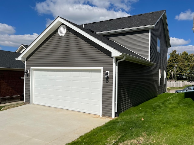 view of home's exterior with a yard and a garage