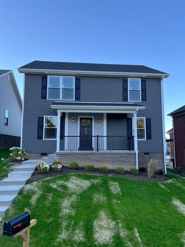 front of property featuring a front lawn and covered porch