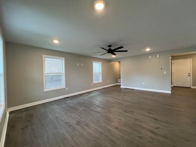 spare room featuring ceiling fan and dark wood-type flooring