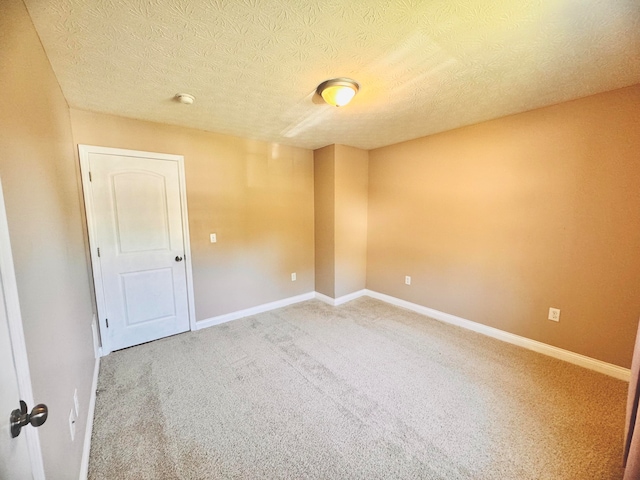 carpeted spare room with a textured ceiling