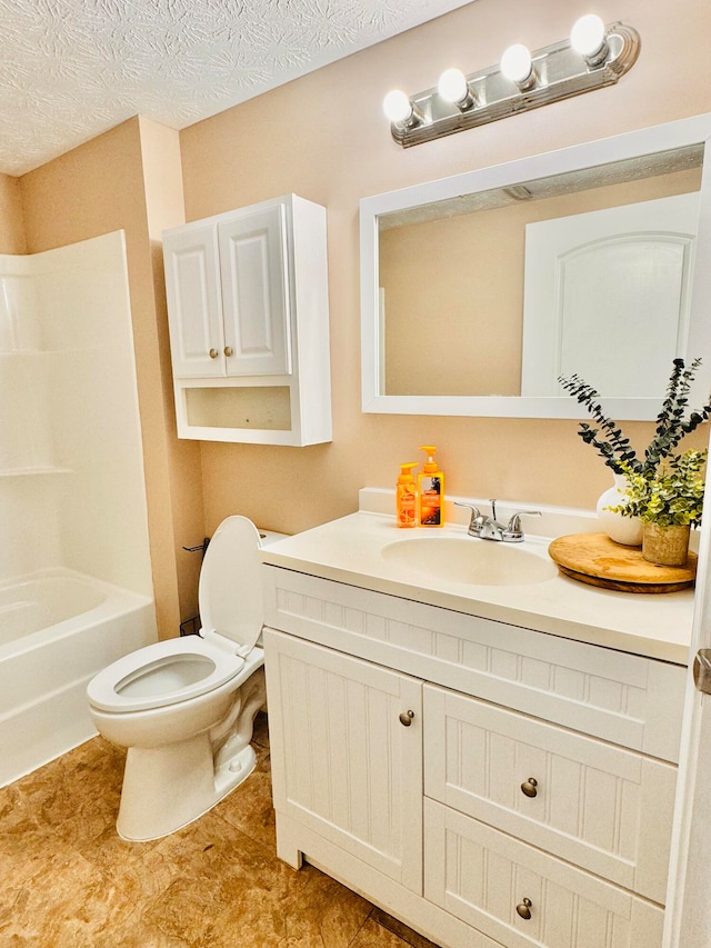 full bathroom with vanity, bathtub / shower combination, toilet, and a textured ceiling