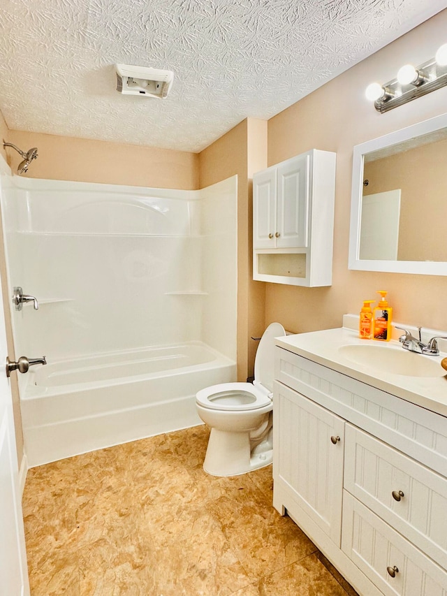 full bathroom with a textured ceiling, vanity, shower / washtub combination, and toilet