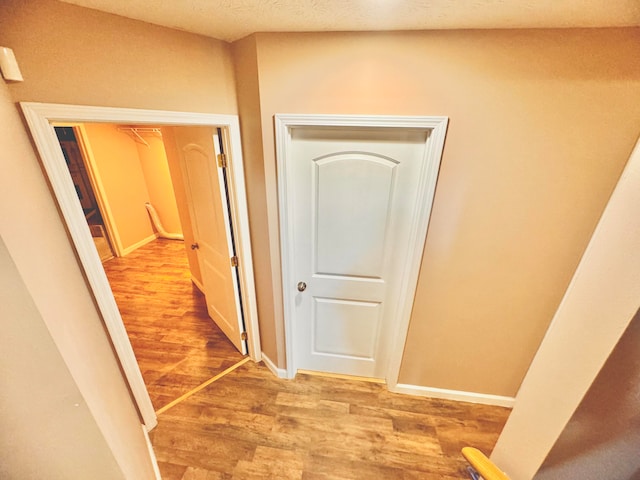 corridor featuring hardwood / wood-style flooring