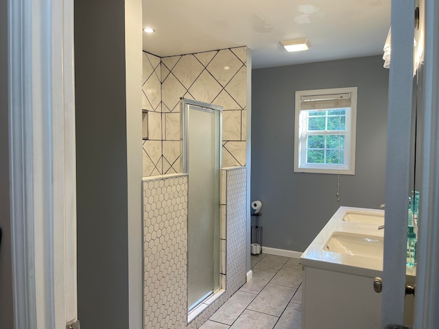 bathroom with tile patterned flooring, vanity, and a shower with shower door