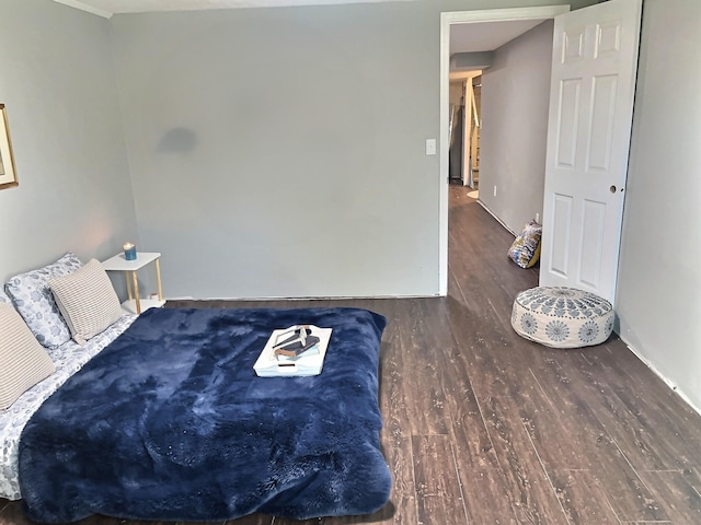 bedroom with dark wood-type flooring