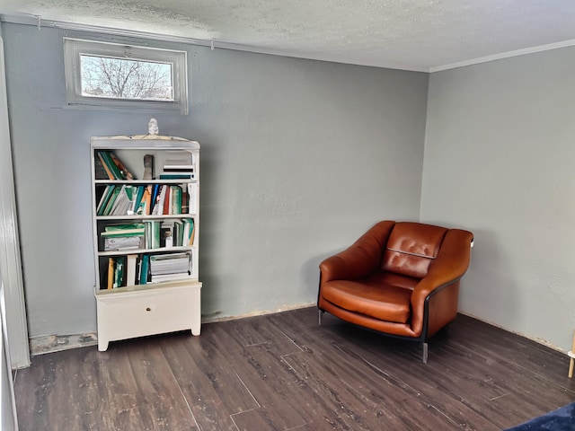 living area with dark hardwood / wood-style flooring and a textured ceiling