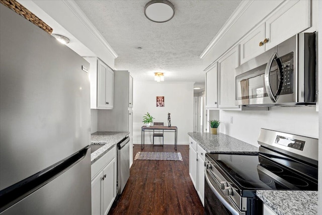 kitchen featuring dark hardwood / wood-style floors, white cabinets, appliances with stainless steel finishes, and a textured ceiling