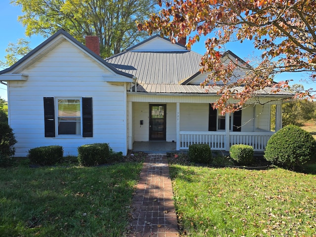 view of front of house with a porch and a front lawn