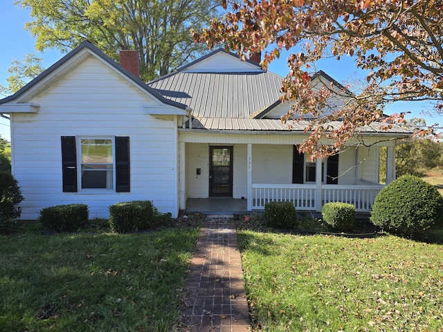 595 Bethel Ridge Rd, Sharpsburg, KY 40374 - bungalow-style house featuring a chimney, a front yard, covered porch, and metal roof