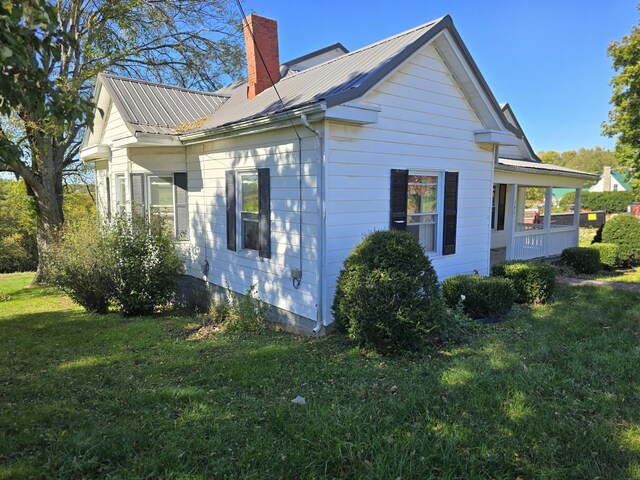 595 Bethel Ridge Rd, Sharpsburg, KY 40374 - view of side of property featuring a yard, a chimney, and metal roof