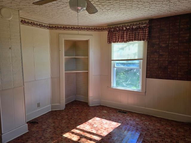 unfurnished room with ceiling fan