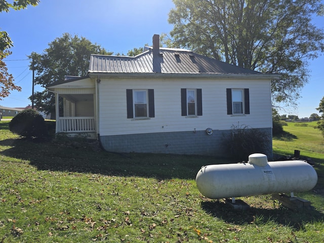 595 Bethel Ridge Rd, Sharpsburg, KY 40374 - view of home's exterior with a yard, a chimney, and metal roof