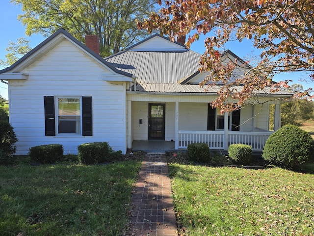 595 Bethel Ridge Rd, Sharpsburg, KY 40374 - bungalow-style home with a chimney, a front lawn, covered porch, and metal roof