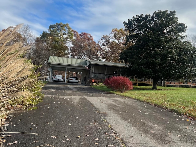 view of front of property with a carport and a front lawn