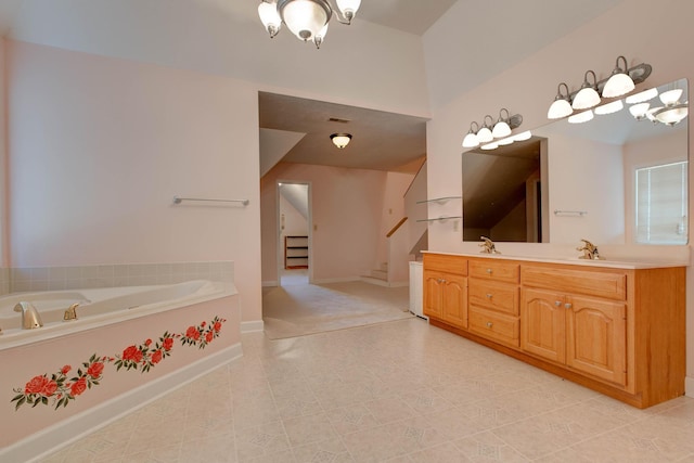 bathroom with a tub and vanity