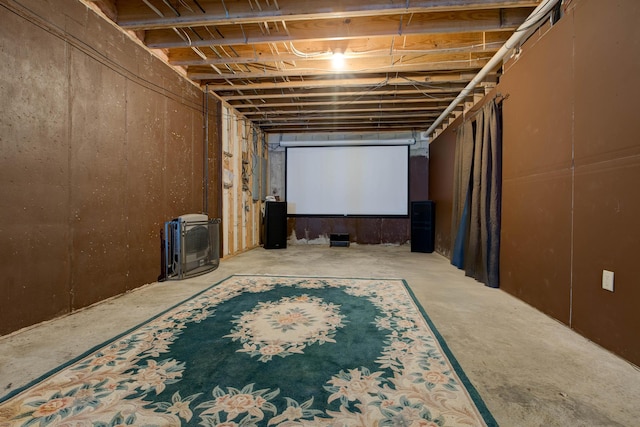 home theater featuring heating unit and concrete floors