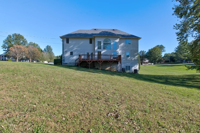 back of house with a lawn and a deck