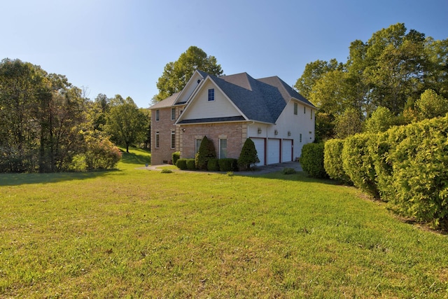 view of side of property with a garage and a yard