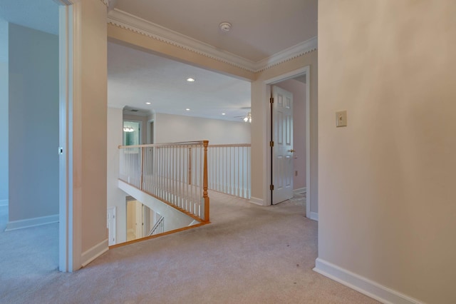 corridor featuring light colored carpet and ornamental molding