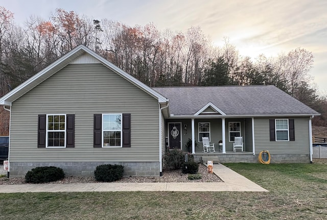 single story home featuring a porch and a yard