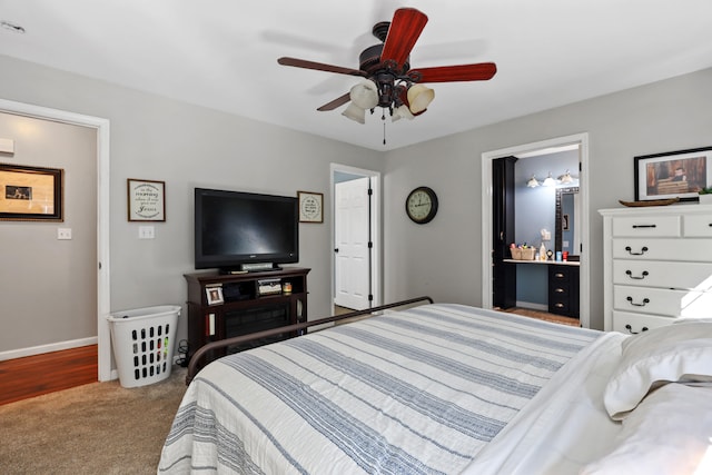 bedroom featuring carpet, ensuite bath, and ceiling fan