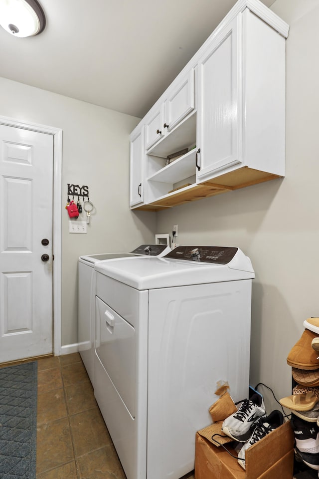 laundry room with washer and dryer and cabinets