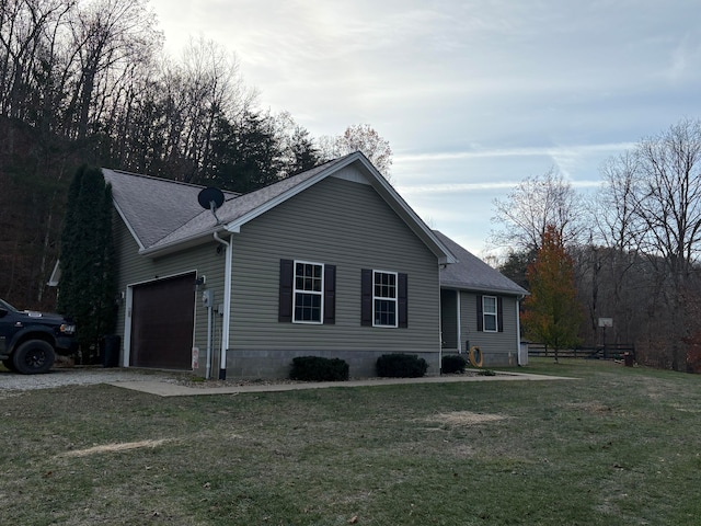 ranch-style home with a garage and a front lawn