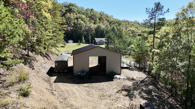 view of property exterior with an outdoor structure